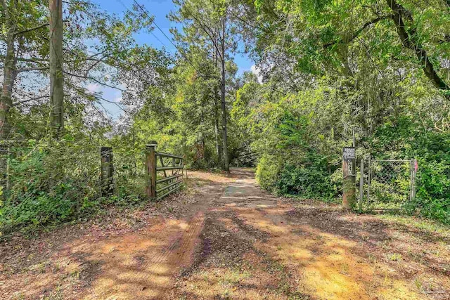 6640 Frank Reeder Rd, Pensacola, FL 32526 - view of street with a gate and a wooded view