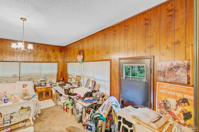 6640 Frank Reeder Rd, Pensacola, FL 32526 - dining space with a textured ceiling, a chandelier, carpet flooring, and wooden walls