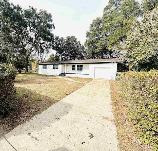 view of front of house with a garage and a front lawn