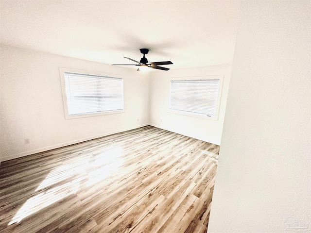 empty room featuring ceiling fan and light hardwood / wood-style flooring