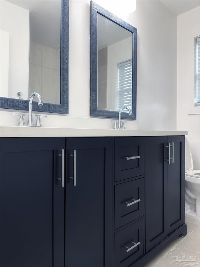 bathroom with vanity, toilet, and tile patterned flooring