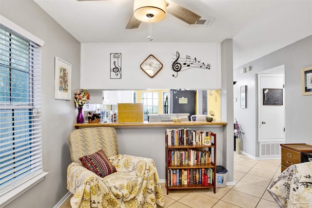 interior space with ceiling fan and light tile patterned flooring