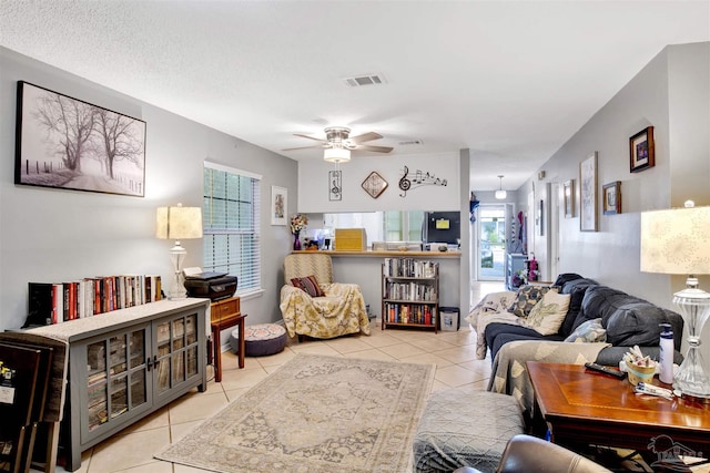 living room with ceiling fan and light tile patterned flooring