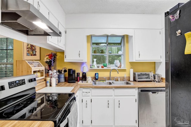 kitchen featuring white cabinetry, sink, stainless steel appliances, and a textured ceiling