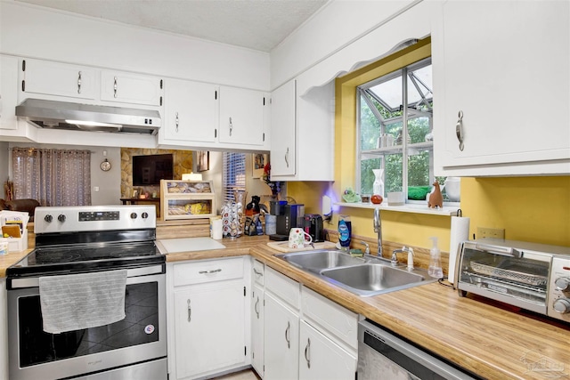 kitchen with white cabinetry, a textured ceiling, and appliances with stainless steel finishes