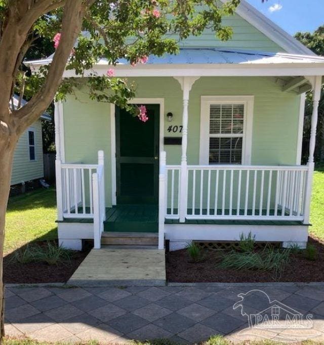 view of exterior entry with a porch