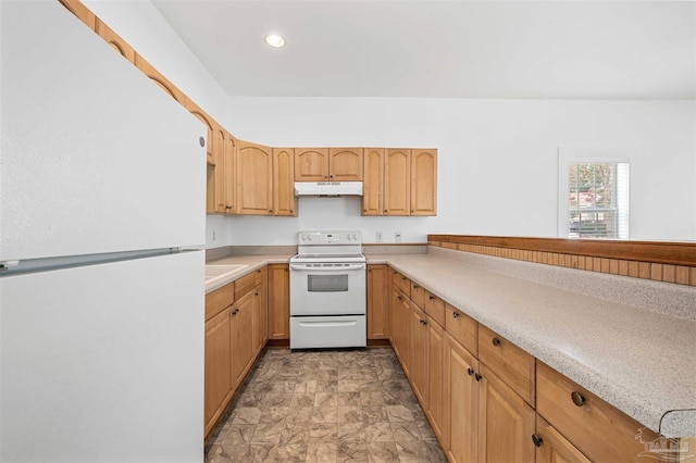 kitchen featuring light brown cabinetry and white appliances