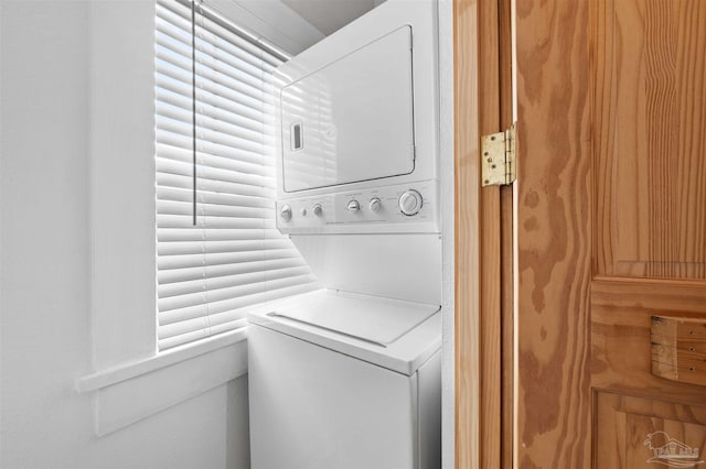 laundry room featuring stacked washer / dryer