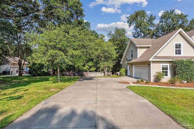 view of property exterior featuring driveway, a garage, a lawn, fence, and board and batten siding