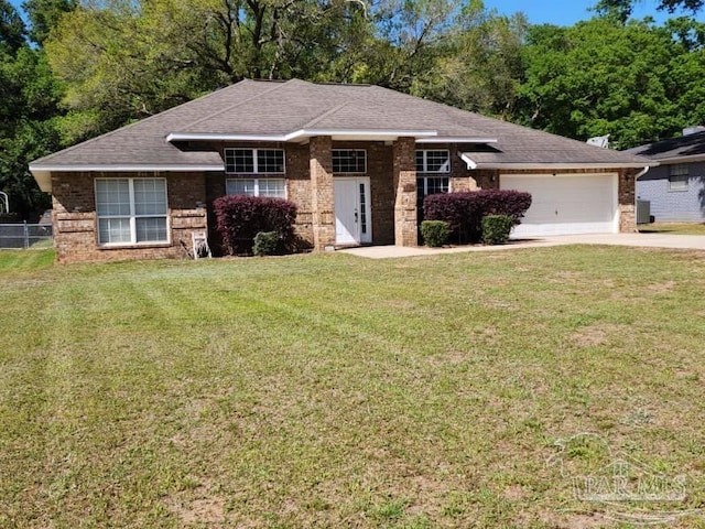 view of front of home with a garage and a front yard