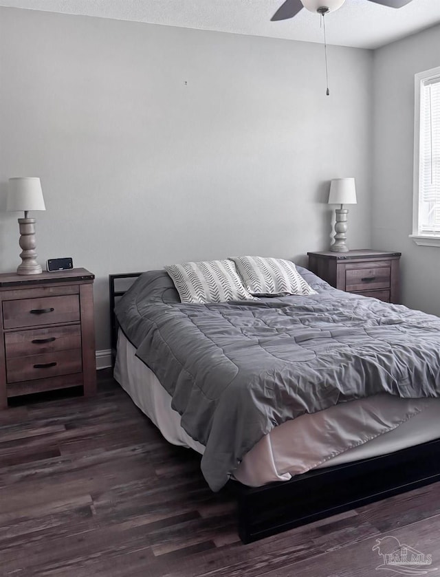 bedroom with dark wood-style floors and ceiling fan
