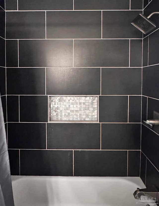 details featuring shower / bath combination with curtain