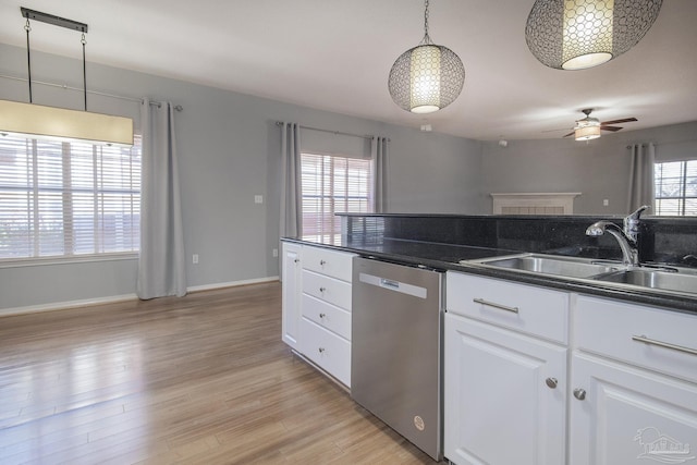 kitchen with white cabinets, sink, hanging light fixtures, stainless steel dishwasher, and ceiling fan