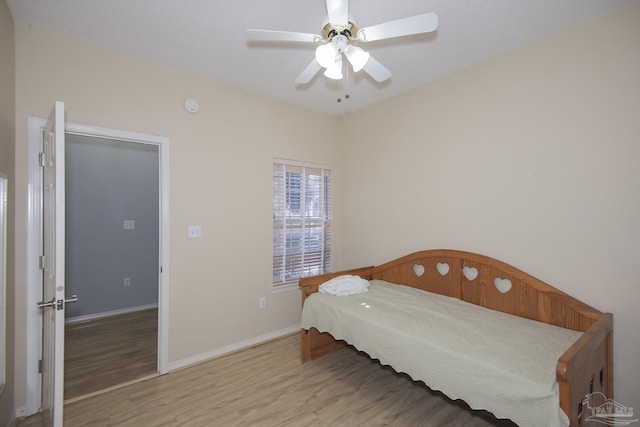 bedroom with ceiling fan and light hardwood / wood-style flooring