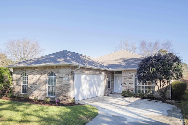 ranch-style house featuring a front yard and a garage