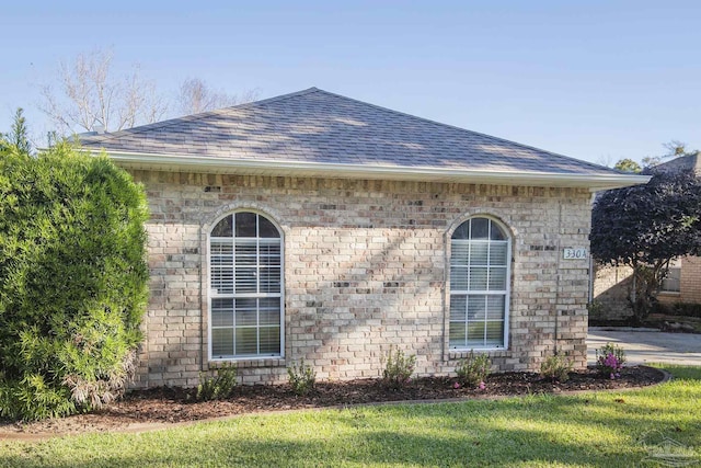 view of side of home featuring a lawn