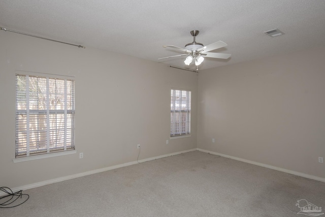 spare room with ceiling fan, carpet floors, and a textured ceiling