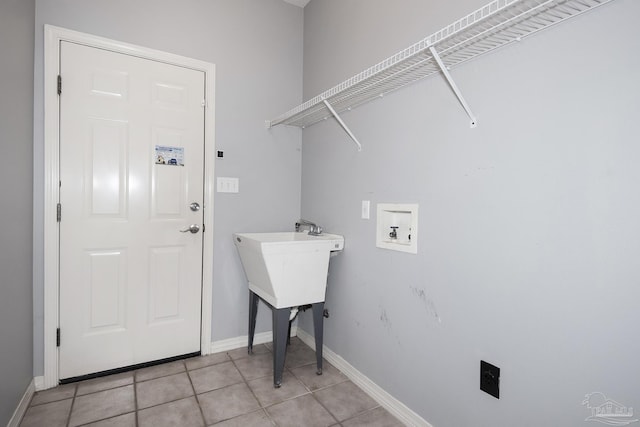 clothes washing area featuring hookup for a washing machine and light tile patterned floors