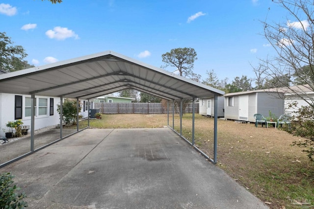 view of parking featuring a carport and a yard