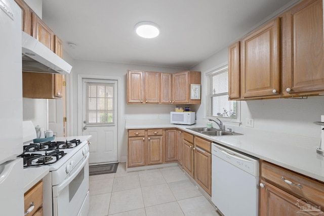 kitchen featuring sink, white appliances, range hood, and light tile patterned floors