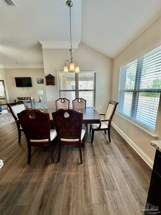 dining area with an inviting chandelier, wood-type flooring, and lofted ceiling