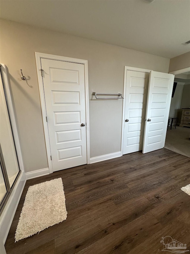 unfurnished bedroom featuring dark hardwood / wood-style floors