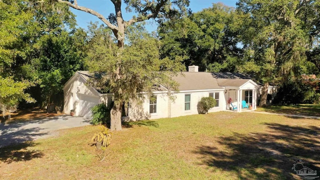 view of front facade with a front yard and a garage