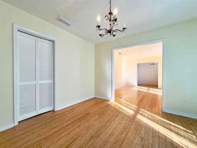 interior space featuring light hardwood / wood-style floors and an inviting chandelier