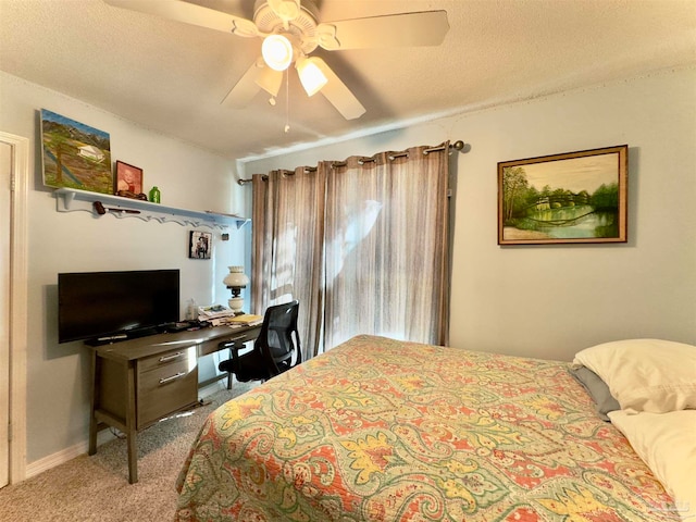 bedroom featuring carpet flooring, ceiling fan, and a textured ceiling