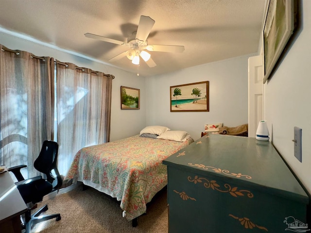 bedroom with carpet flooring, ceiling fan, and a textured ceiling