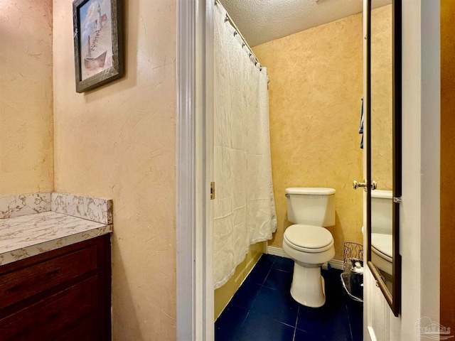 bathroom featuring tile patterned floors, vanity, a textured ceiling, and toilet