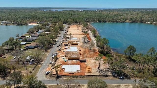 aerial view with a forest view and a water view