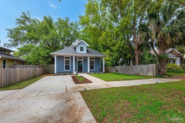 bungalow-style home with covered porch and concrete driveway