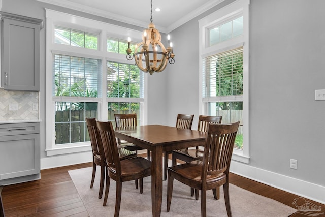 dining space with a chandelier, crown molding, dark wood-style flooring, baseboards, and recessed lighting
