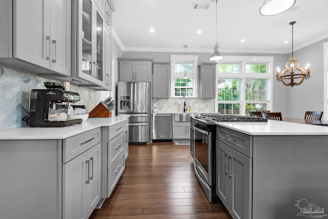 kitchen featuring gray cabinetry, appliances with stainless steel finishes, ornamental molding, and recessed lighting