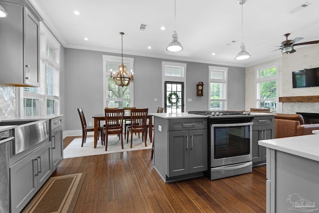 kitchen featuring stainless steel range with gas cooktop, gray cabinetry, ornamental molding, recessed lighting, and light countertops