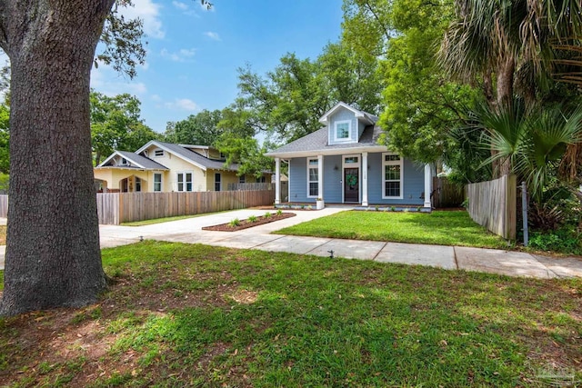 bungalow-style house with driveway and covered porch