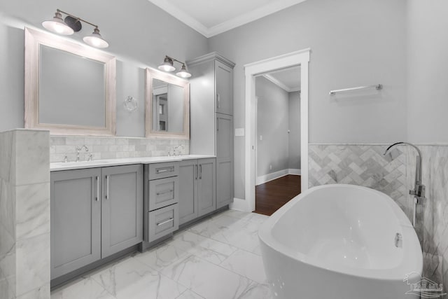bathroom featuring a freestanding bath, double vanity, crown molding, marble look tiles, and tile walls