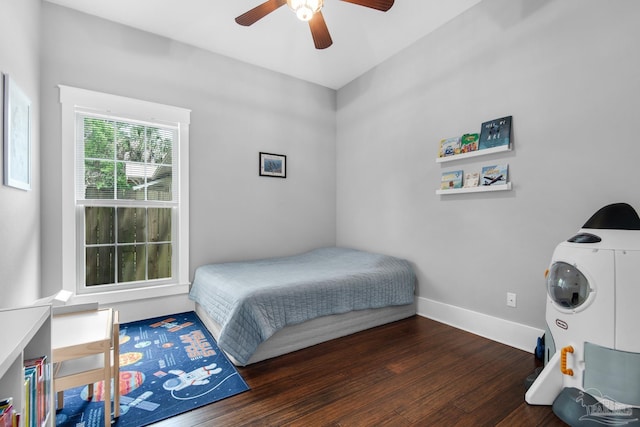 bedroom with wood finished floors, baseboards, and a ceiling fan