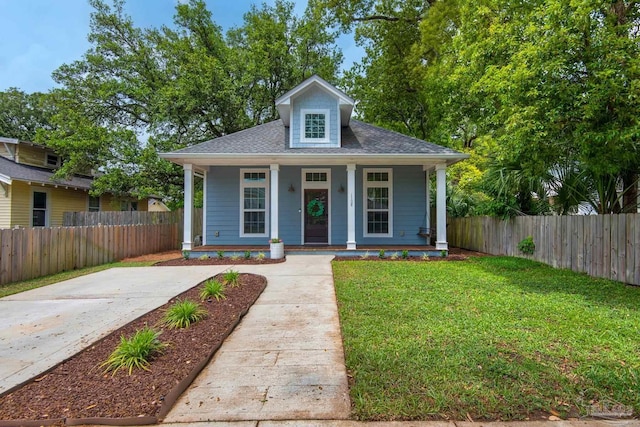 bungalow-style home with covered porch and roof with shingles
