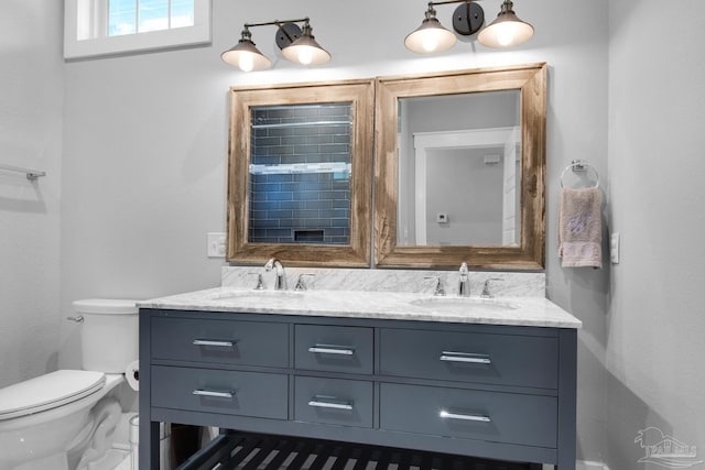 full bath featuring toilet and double vanity