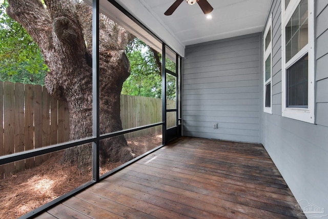 unfurnished sunroom featuring a ceiling fan