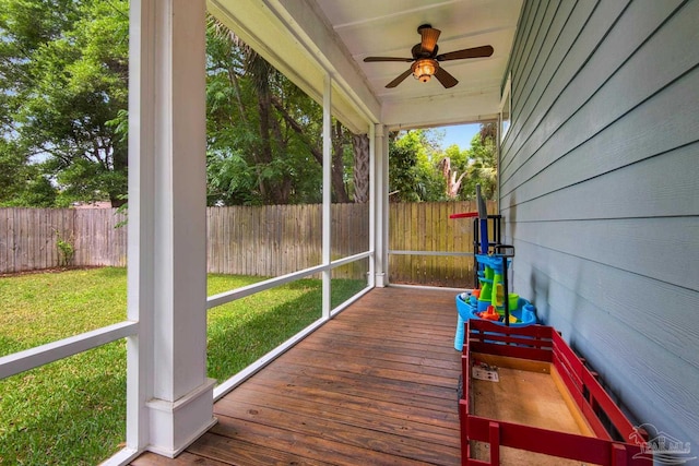 sunroom featuring a ceiling fan and healthy amount of natural light