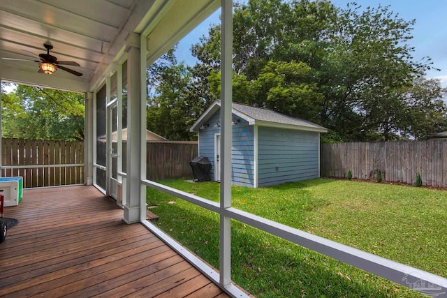unfurnished sunroom featuring a ceiling fan