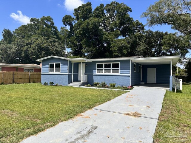 ranch-style house featuring a front lawn and a carport