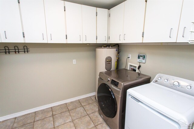 7402 Viewcrest Dr, Pensacola, FL 32504 - laundry area with cabinet space, separate washer and dryer, baseboards, water heater, and light tile patterned floors