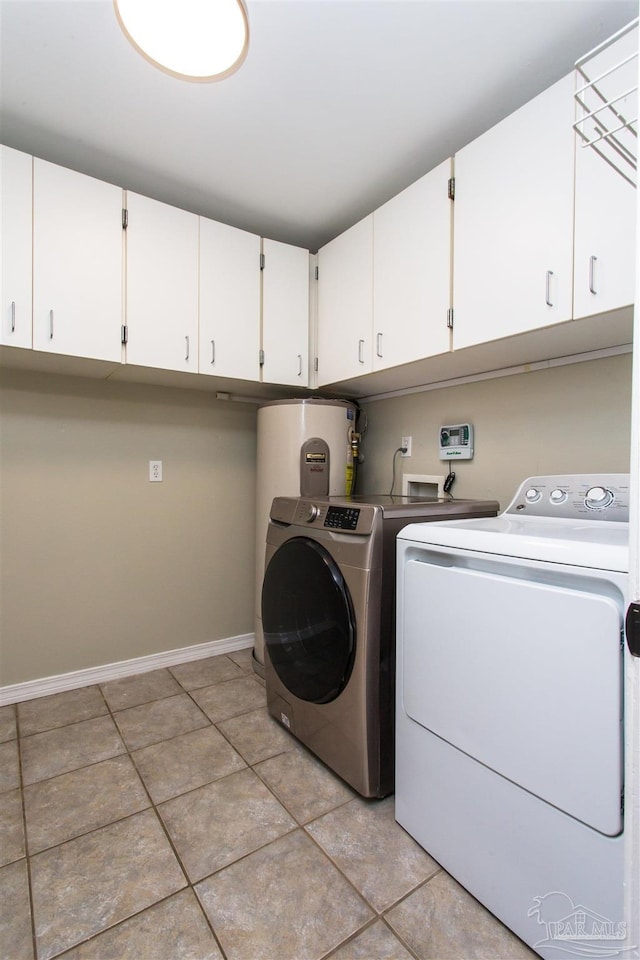 7402 Viewcrest Dr, Pensacola, FL 32504 - washroom featuring cabinet space, separate washer and dryer, light tile patterned floors, and baseboards