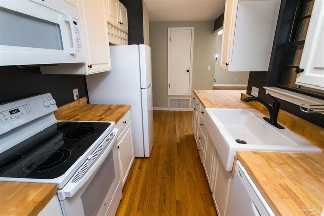 7402 Viewcrest Dr, Pensacola, FL 32504 - kitchen featuring wood counters, white appliances, wood finished floors, a sink, and white cabinetry
