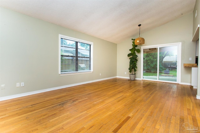 7402 Viewcrest Dr, Pensacola, FL 32504 - unfurnished room featuring vaulted ceiling, light wood-style flooring, baseboards, and a textured ceiling