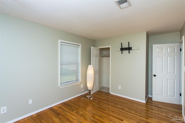 7402 Viewcrest Dr, Pensacola, FL 32504 - unfurnished bedroom with wood finished floors, baseboards, and a closet
